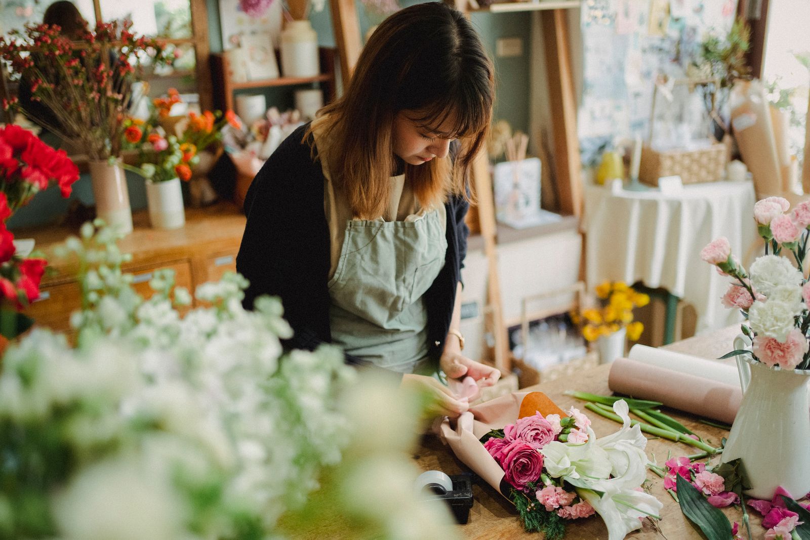 A florist creating a fresh, contemporary arrangement